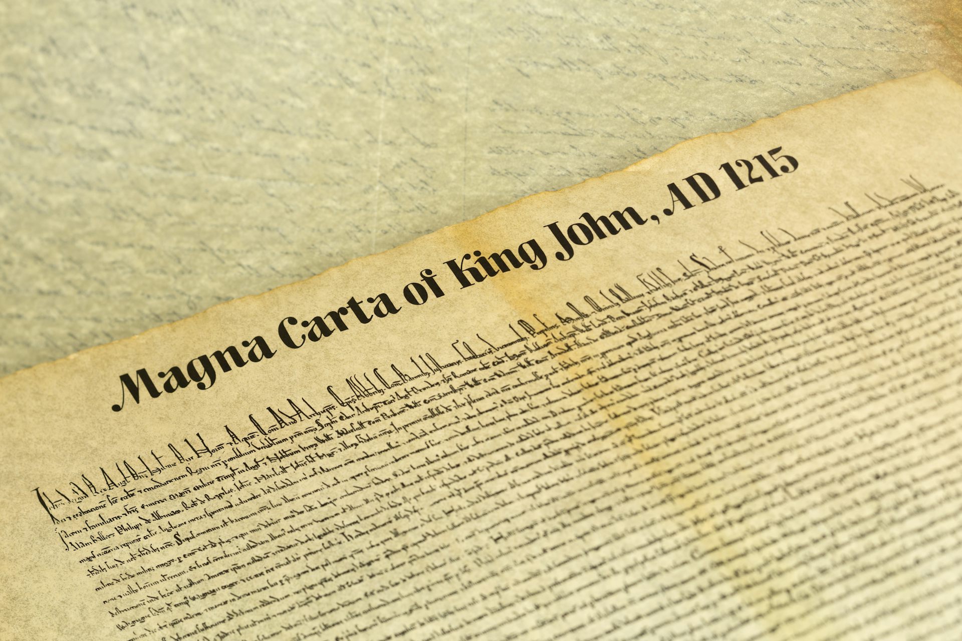 A close up shot of an ancient document, reading 'Magna Carta of King John, AD 1215'