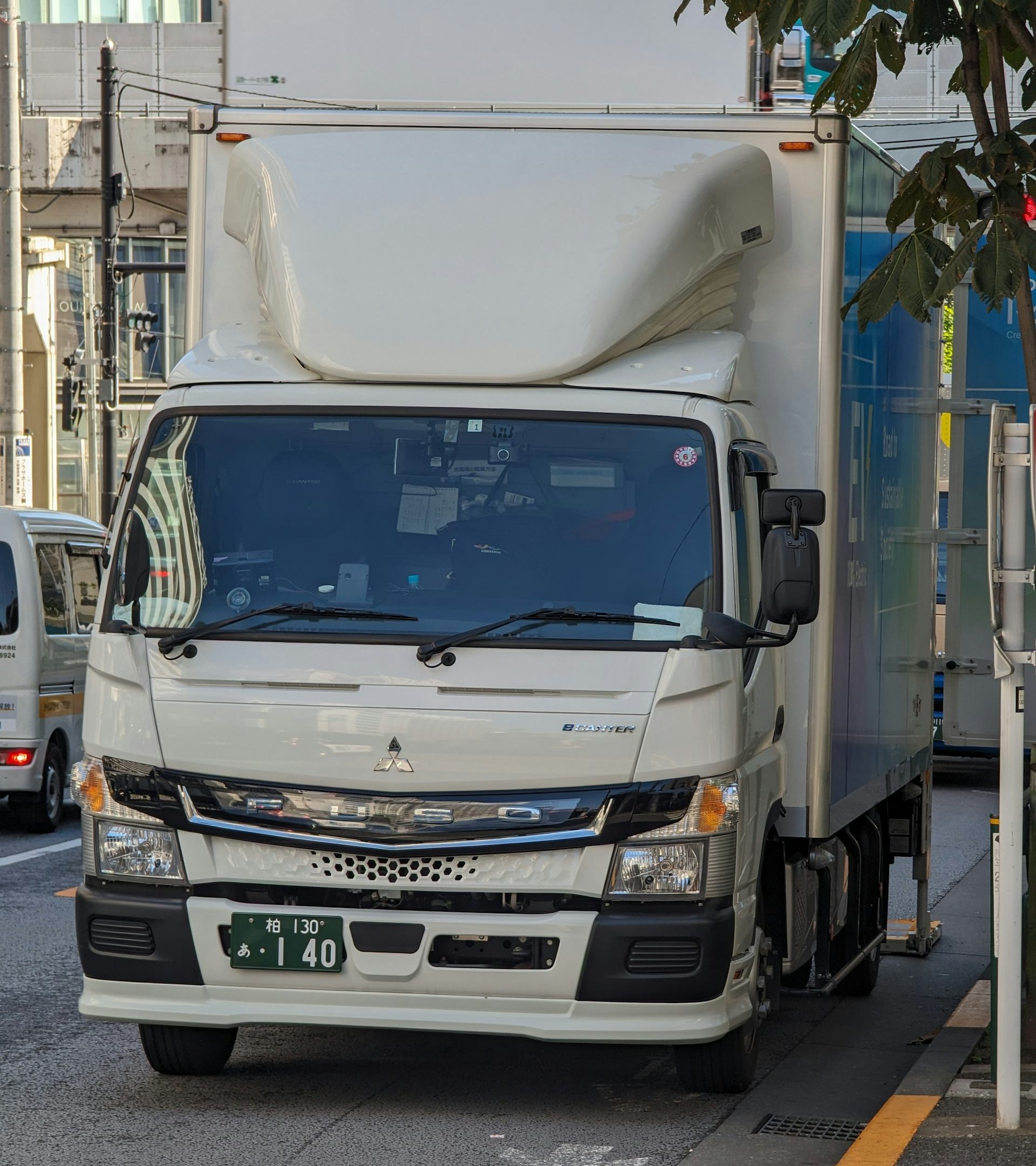 Mitsubishi Fuso eCanter electric light duty truck driving down a city street