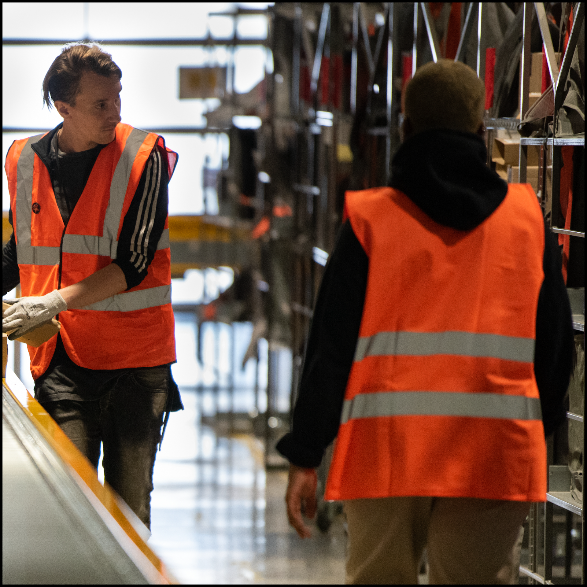Photo of worker in hi-vis jacket picking stock
