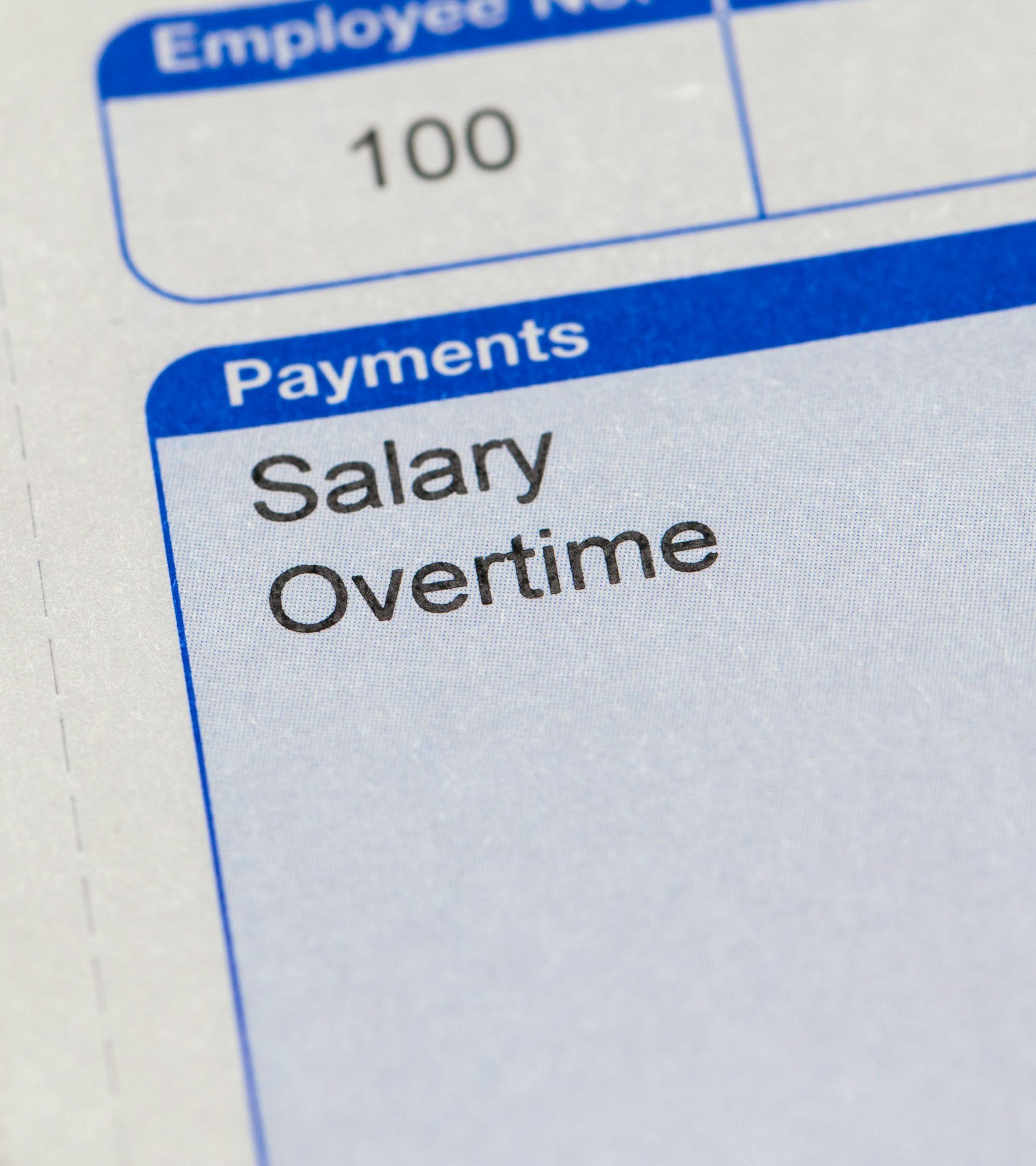 Super close up of payslip showing words salary and overtime