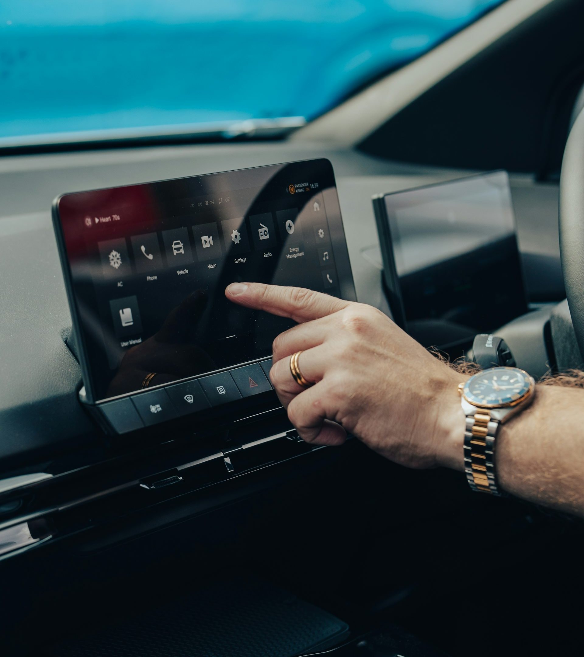 Man controlling dashboard on an electric vehicle.