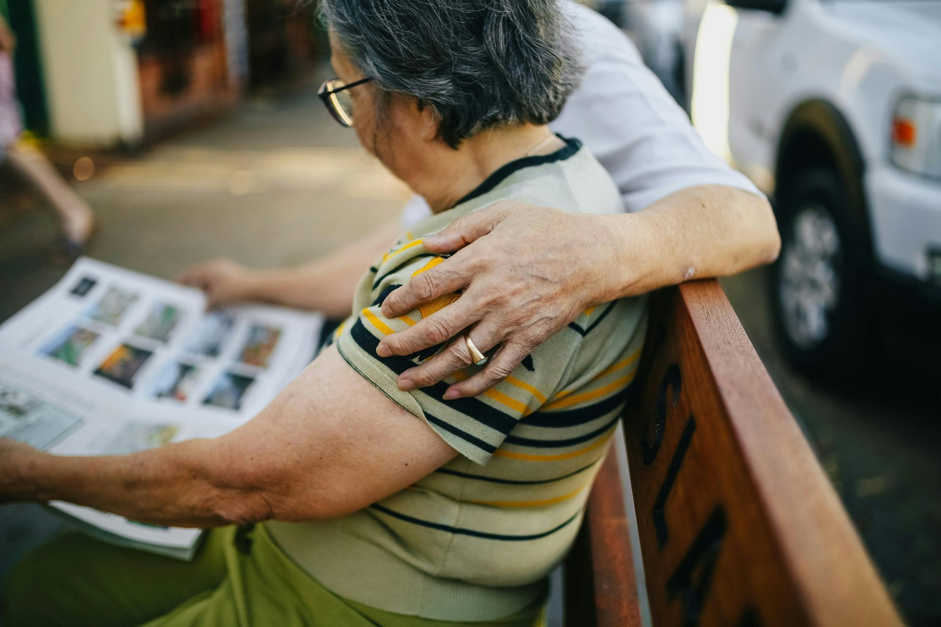 An older Asian man and woman look at property listings.