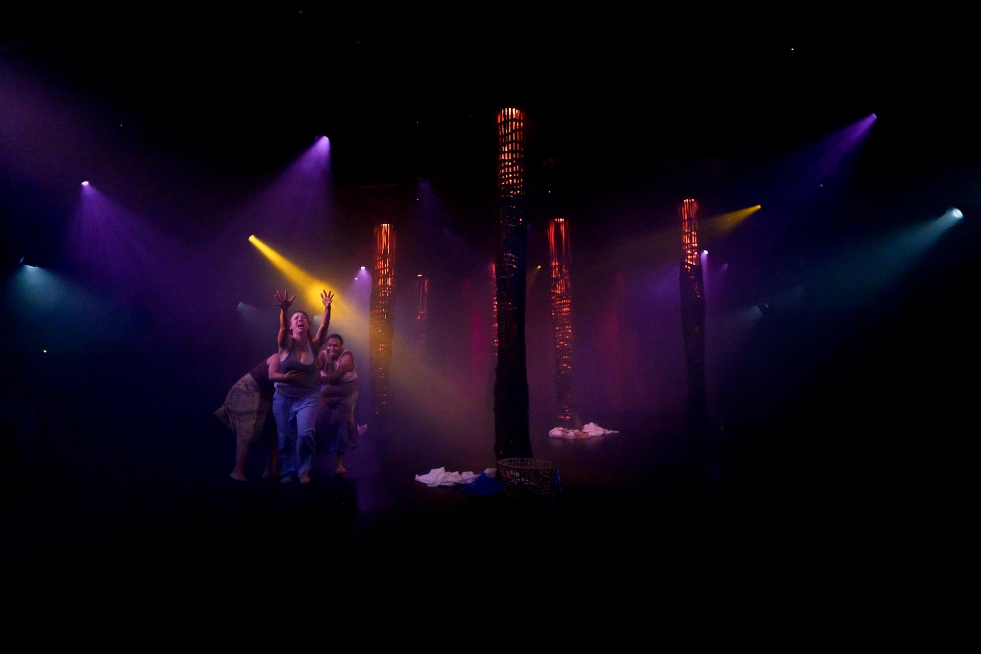 Out of the stage lights, you can just see three women yelling.