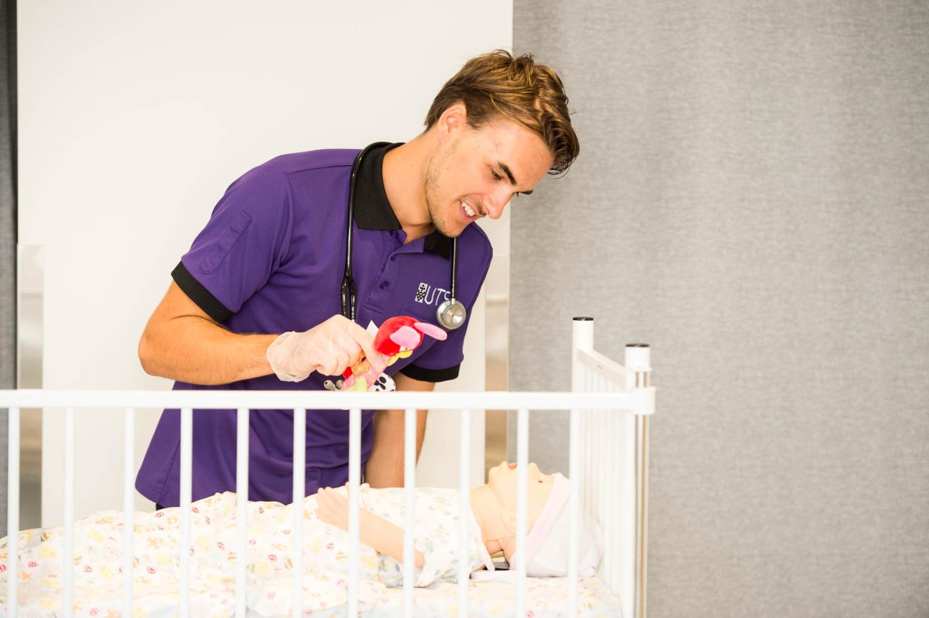 Nursing student engages with a robotic baby patient