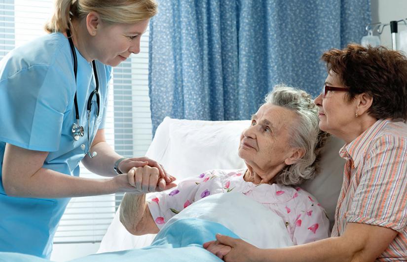 Palliative Care patient and family member speak to their doctor in hospital