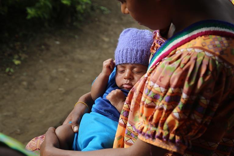 Mother cradling her baby