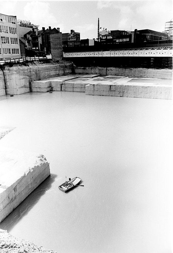 Black and white photo of a body of water with a boat floating across it