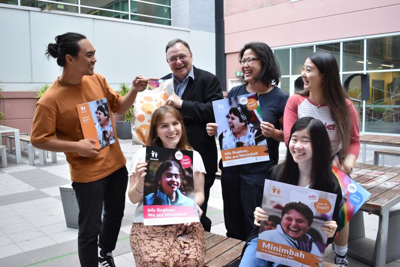 Shopfront students hold posters of the work they completed for Minimbah