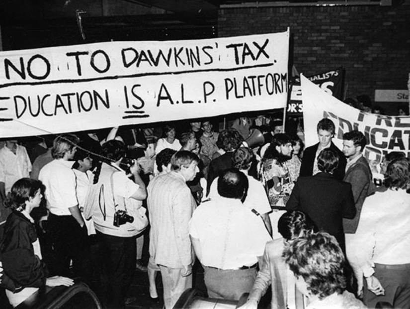 Crowd of people holding a sign 