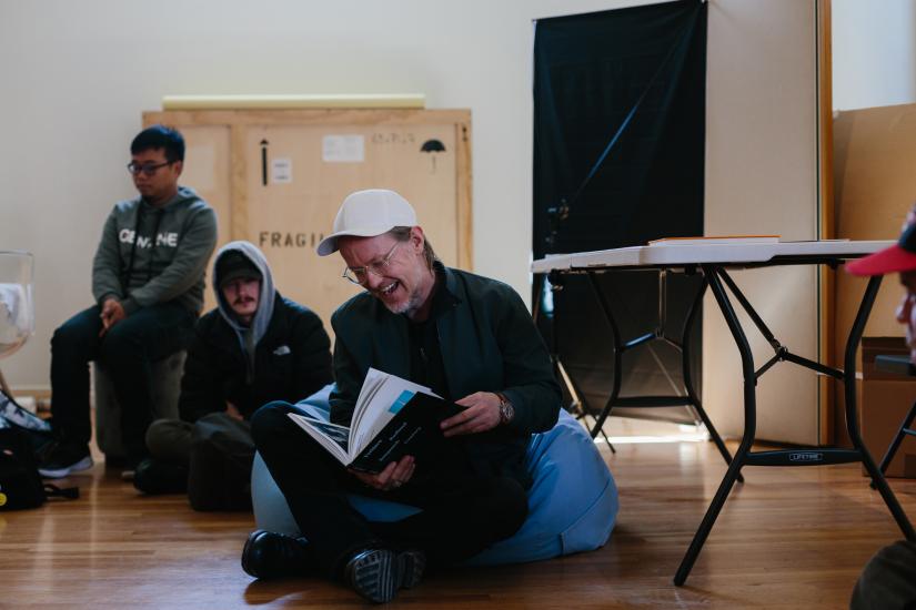 Photographic artist Torbjorn Rodland sits holding photo book