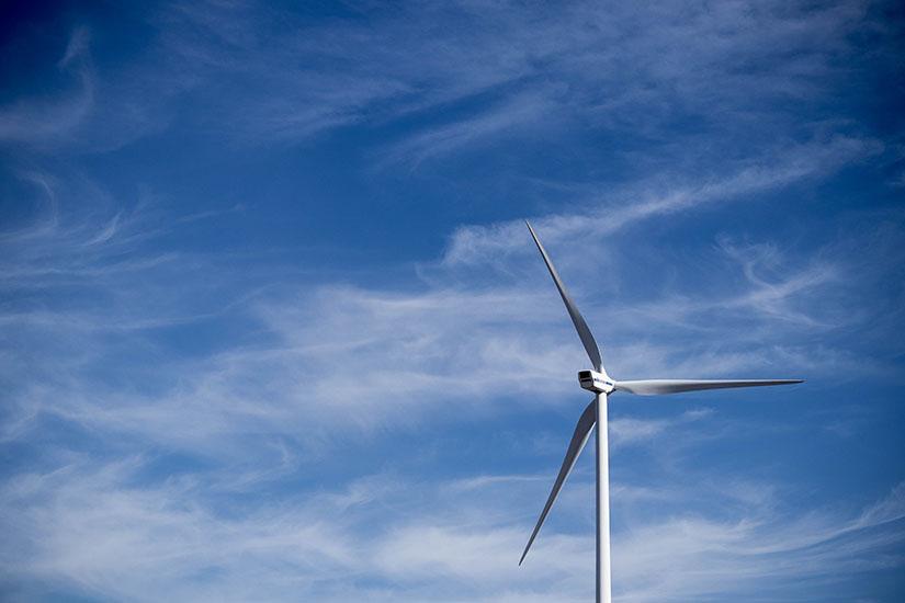 Wind turbine against a blue sky background.