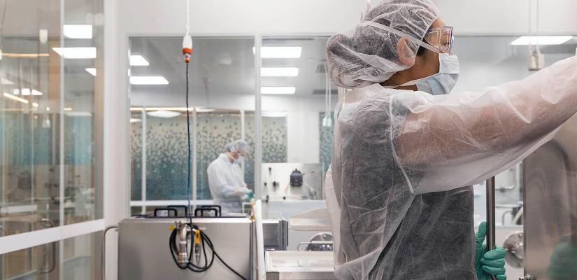 Gowned researchers at work in the Biologics Innovation Facility