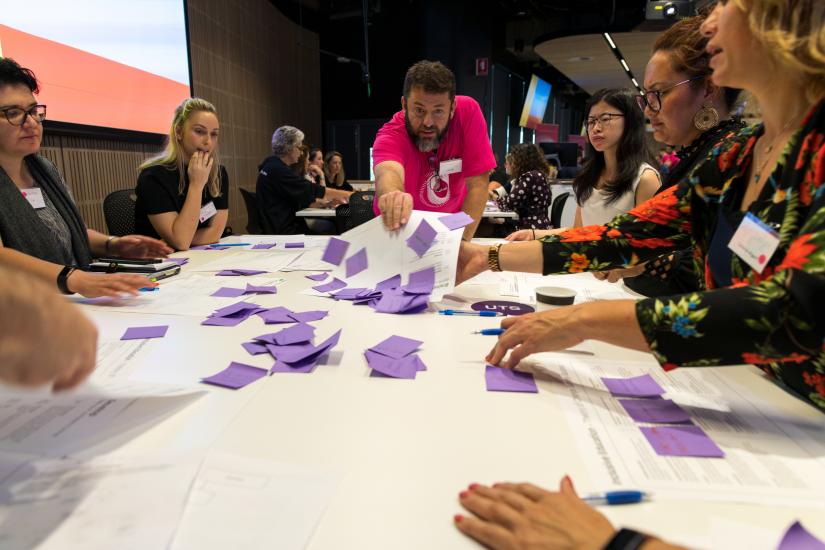 UTS Equity and Diversity training specialist Arif Ongu lifting butchers paper off a table.