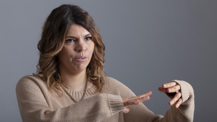 Shannan Dodson talking and making expressive hand gestures