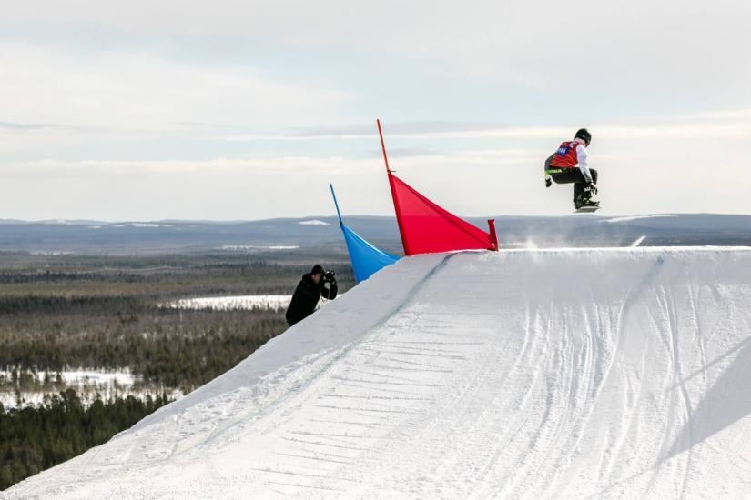 Sportsman of the year Benjamin Tudhope snowboarding up a slope. There is also someone taking a photo of him