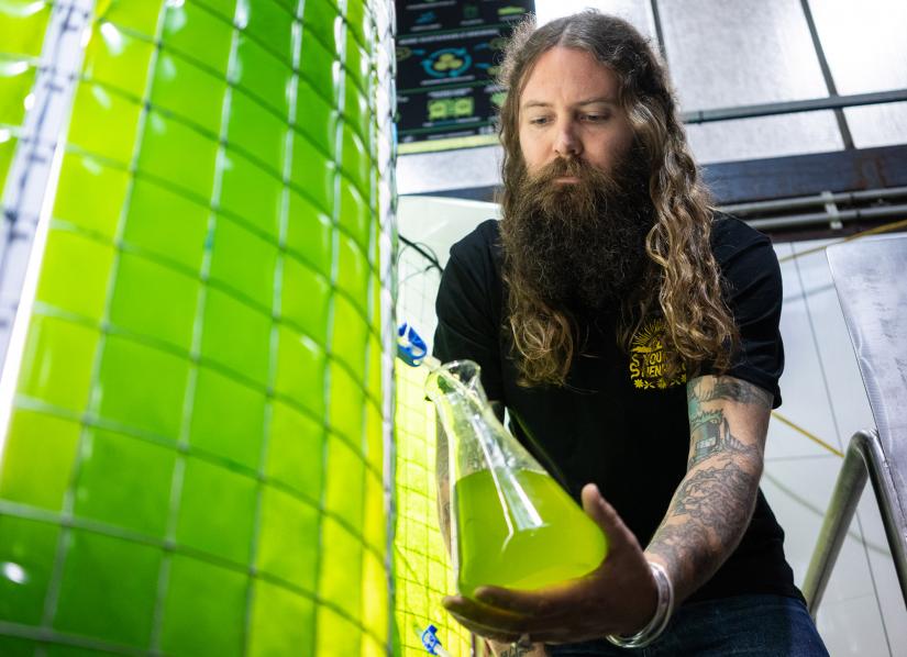 Young Henrys co-founder Oscar McMahon with one of the bioreactors