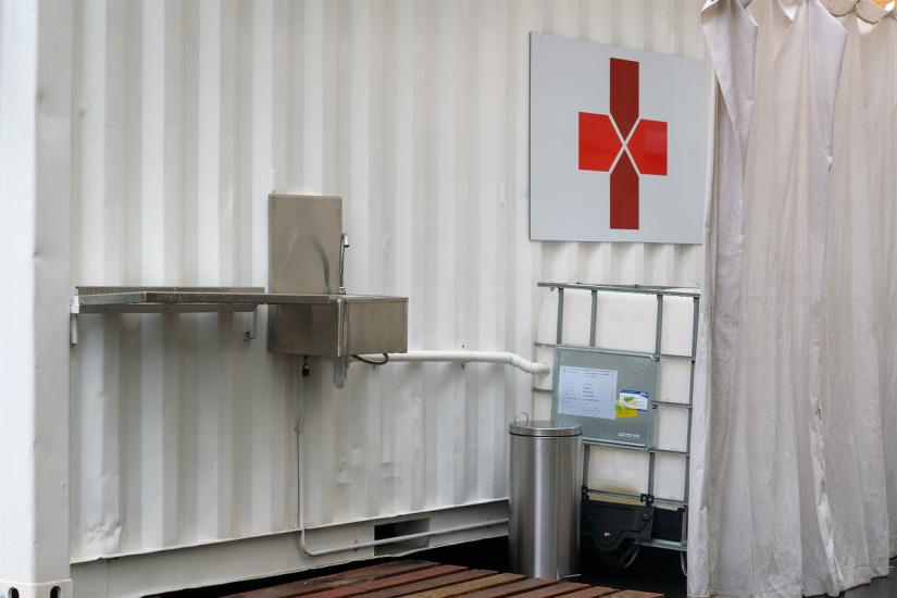 close up of the shipping container structure, the washbasin, curtain and water tank