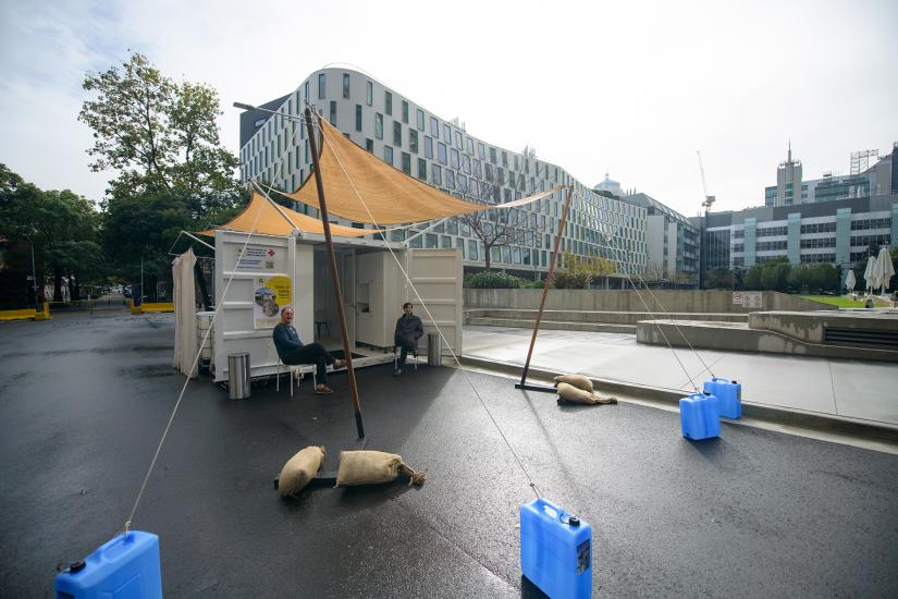 a shipping container structure, sits on a street adjacent to UTS