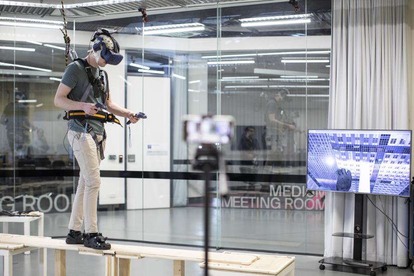 A participant uses virtual reality and physical props in a cognitive stress experiment