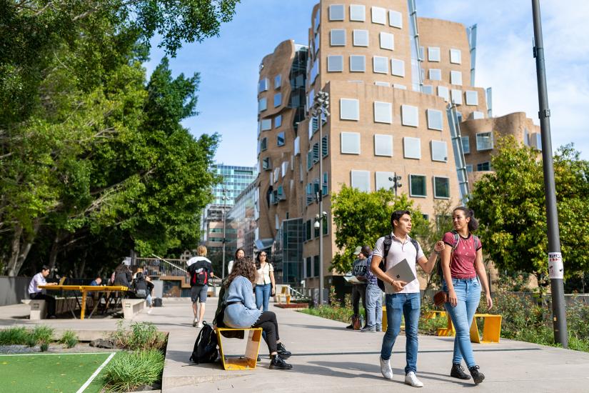 Business students mingle outdoors outside UTS Business School