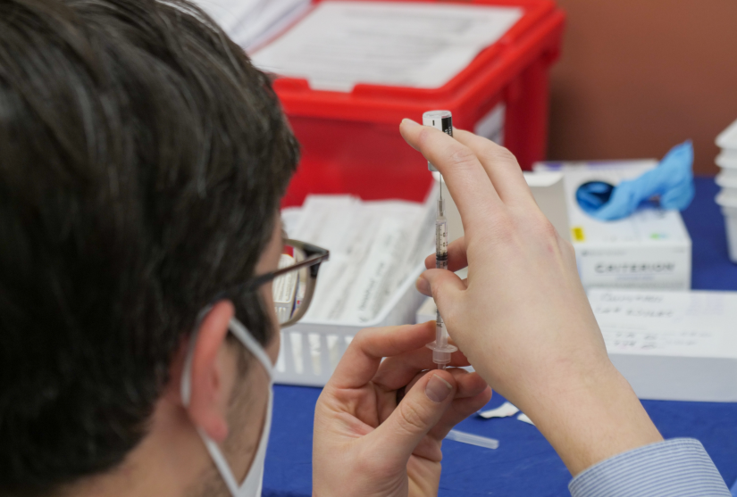 A GP prepares a COVID-19 vaccine