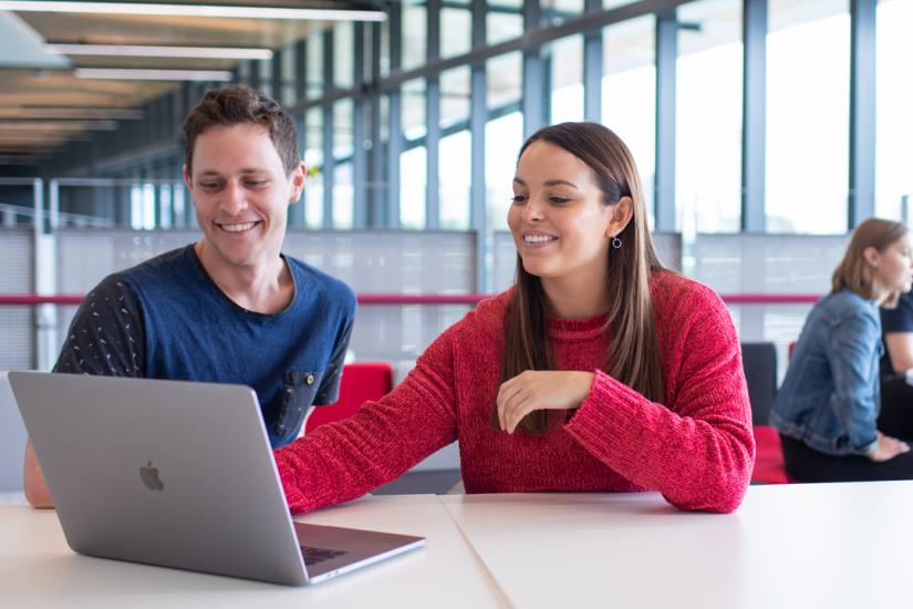 Students working on a laptop together.