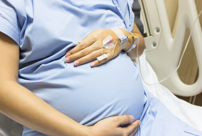 A pregnant woman in a hospital bed