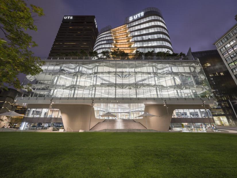 Illuminated UTS Central building with Tower in background, night