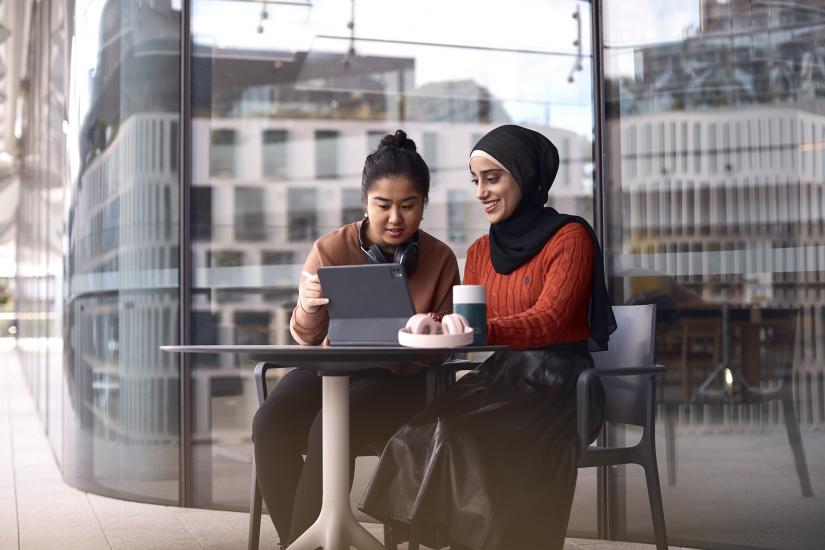 UTS students working on project sitting together with mobile tablet