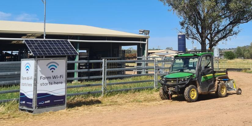 RF antenna Wifi generator in front of farm shed with tractor