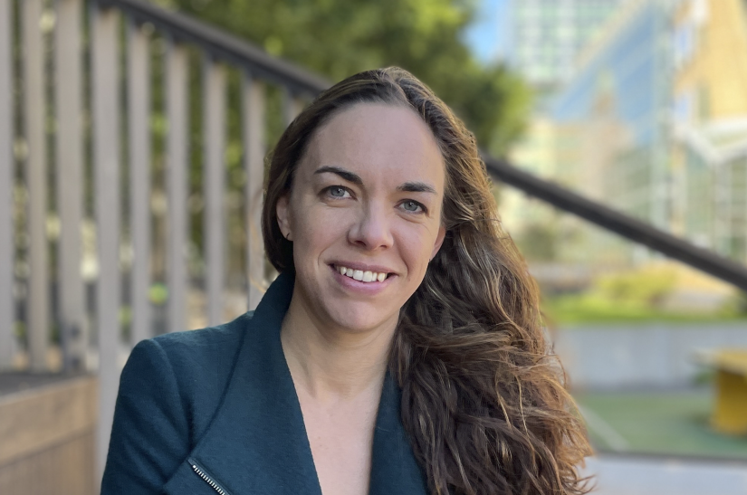 A portrait of a woman smiling at the camera