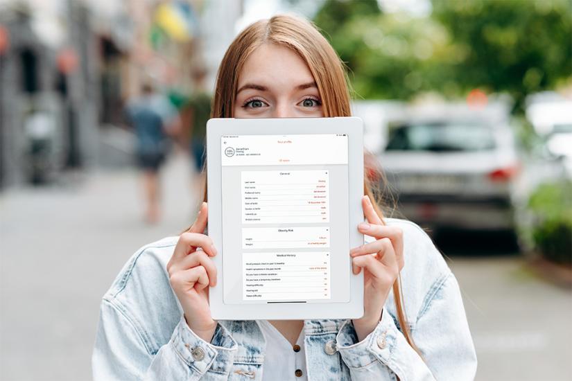 Woman holding an iPad with data