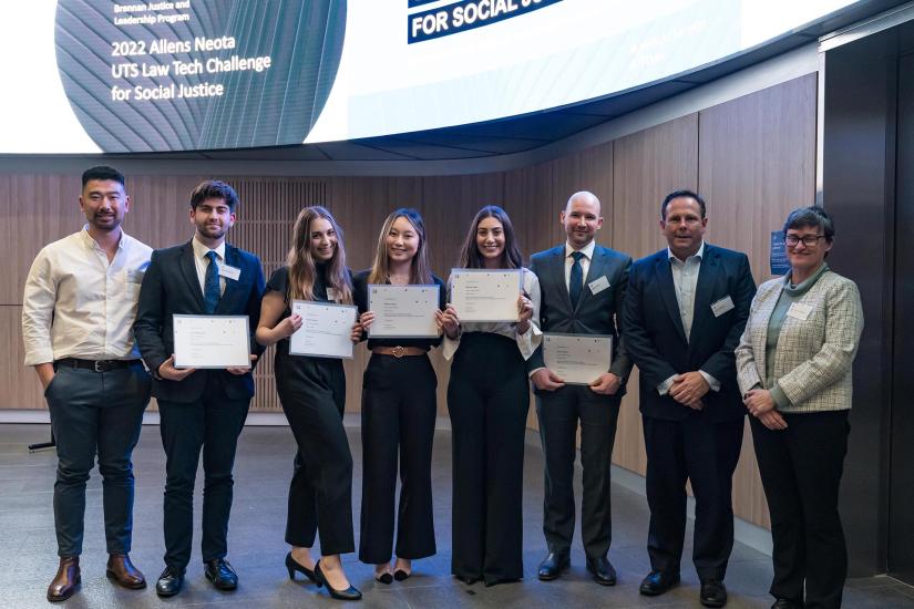 The winning team and judges pose with awards