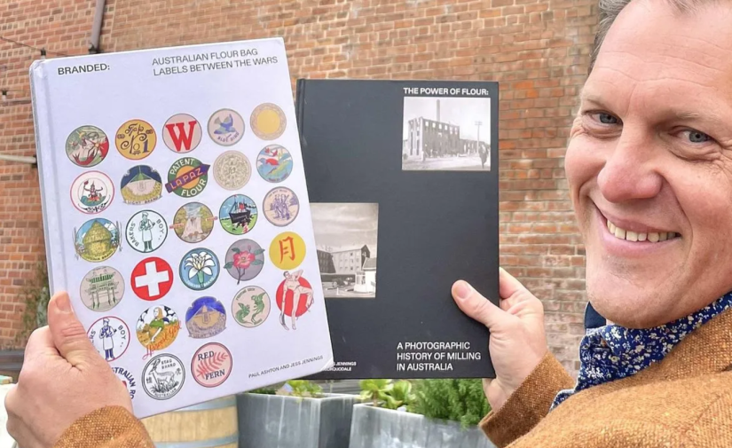 Man holding books and looking at the camera