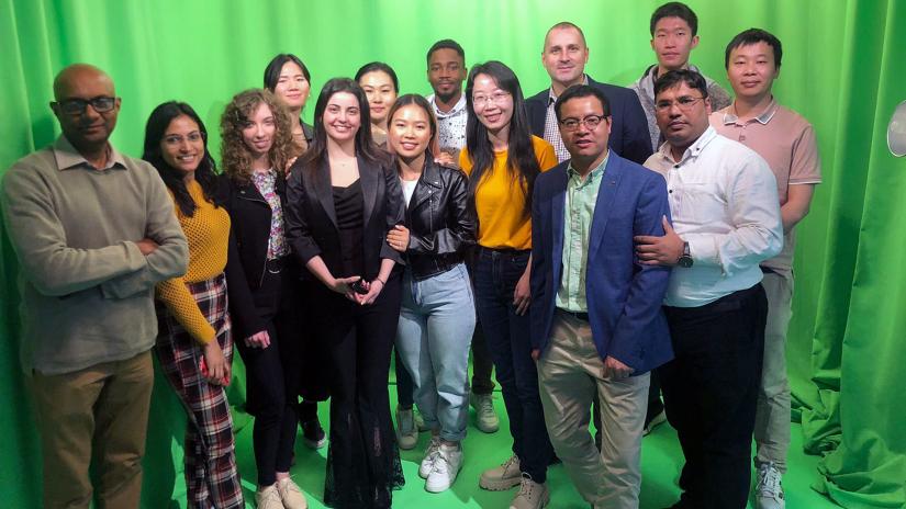 Group shot in front of green curtains