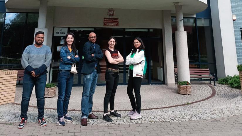 Five students in front of a building