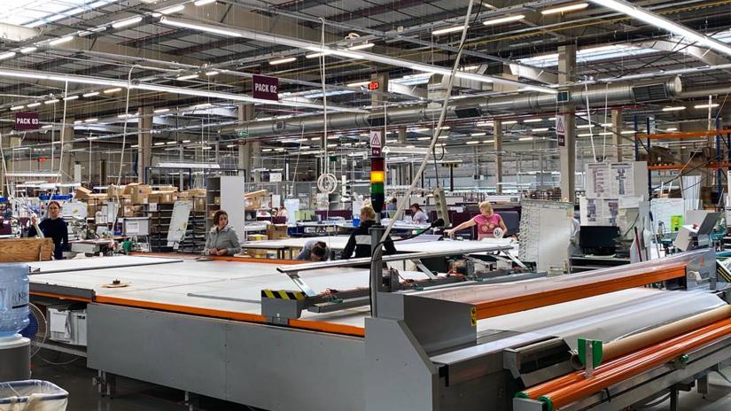 Workshop participants visit a factory that is using the Agile Management framework