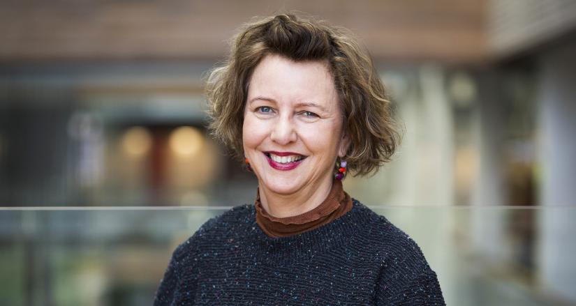 A portrait of a woman smiling at the camera