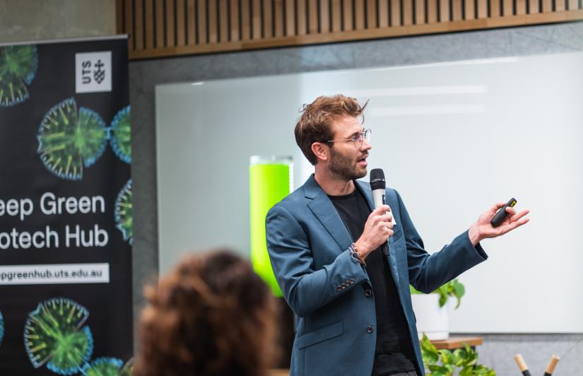 An entrepreneur pitching their sustainable business idea at a pitch event
