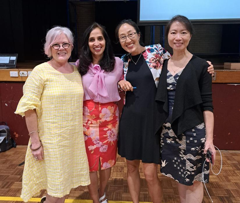 Group photo of four female senior educators inside a school gym