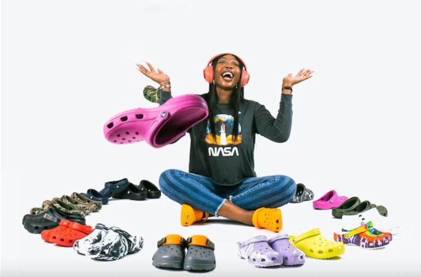 A woman surrounded by Crocs
