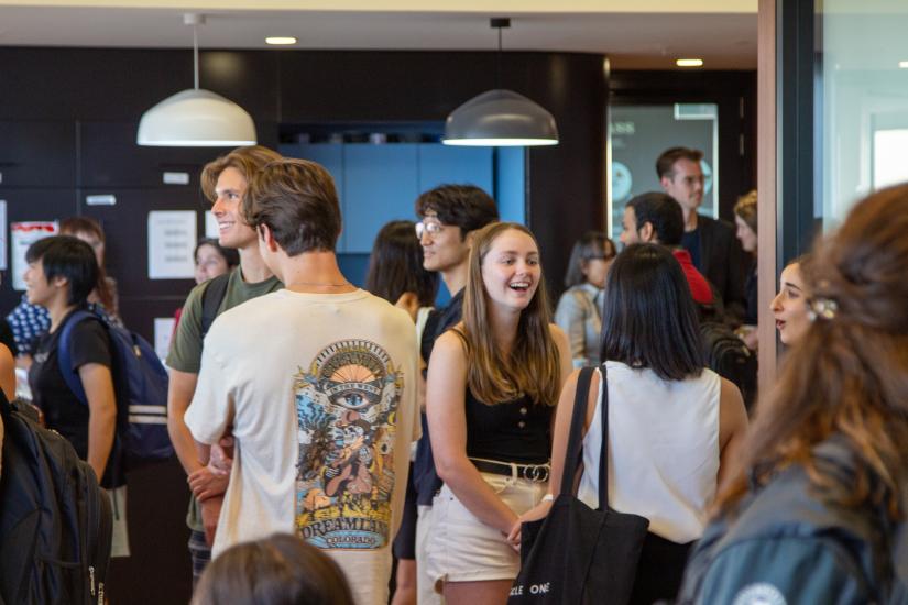 students talk with each other in a busy room