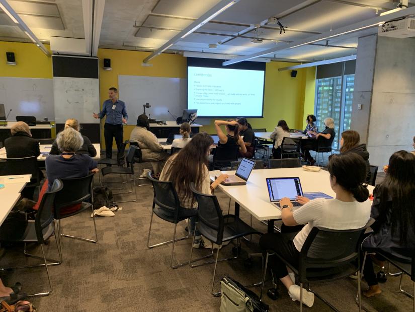 Man giving a workshop to a classroom of students.