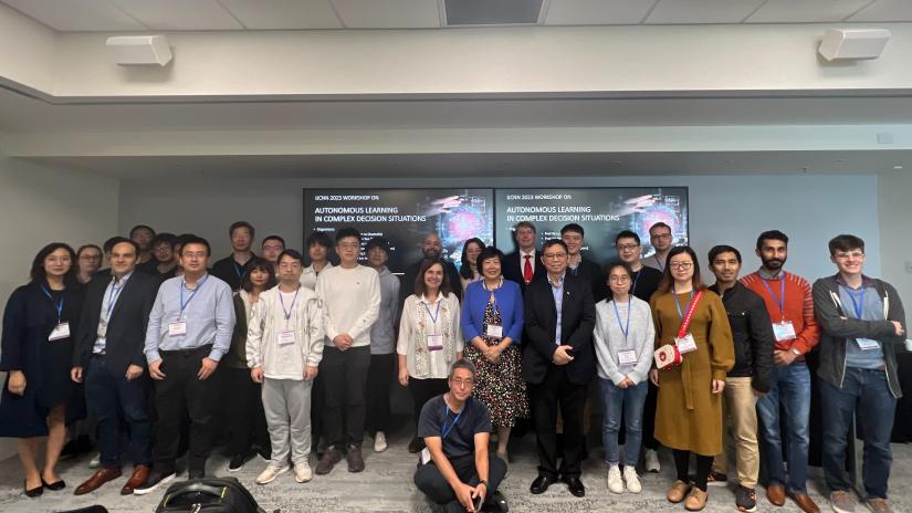 A group shot of 40 audience members from UTS-SUSTech Research collaboration. They are standing in a group inside a seminar room with two seminar screens behind them, which display a title page of the Conference Workshop. The title is Autonomous Learning in Complex Decision Situations Autonomous Learning in Complex Decision Situations Autonomous Learning in Complex Decision Situations