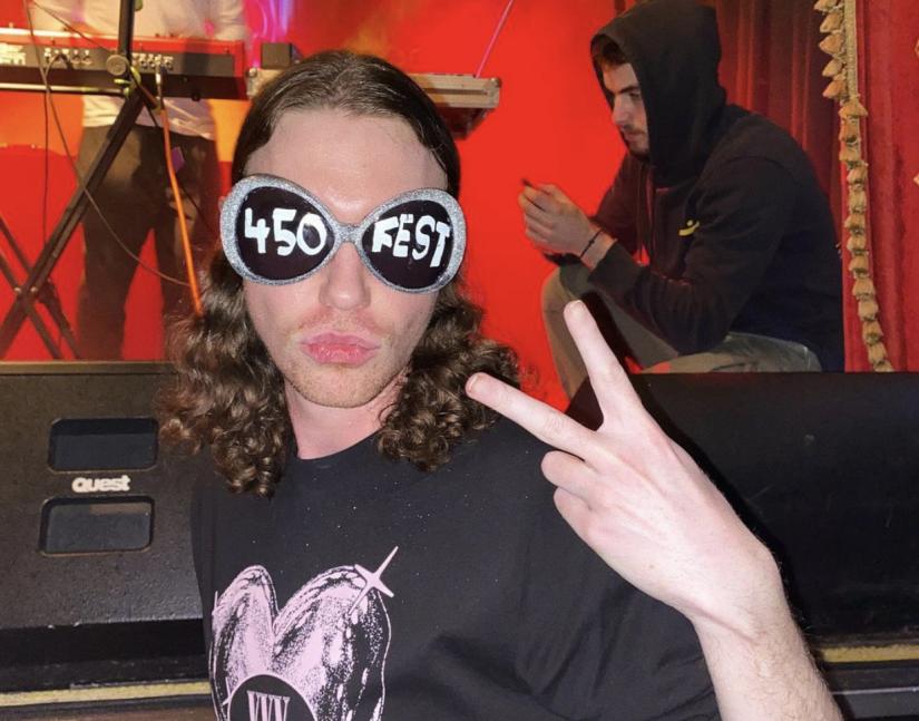 A student poses for the camera wearing 450 sunglasses