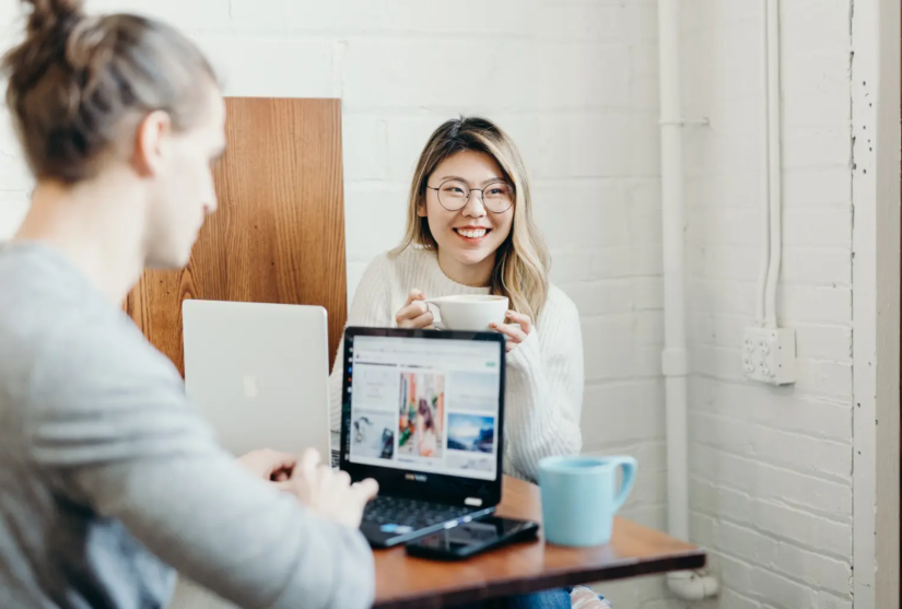 Students collaborating around a laptop