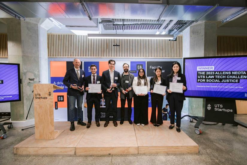 The winning team accepting their award on stage