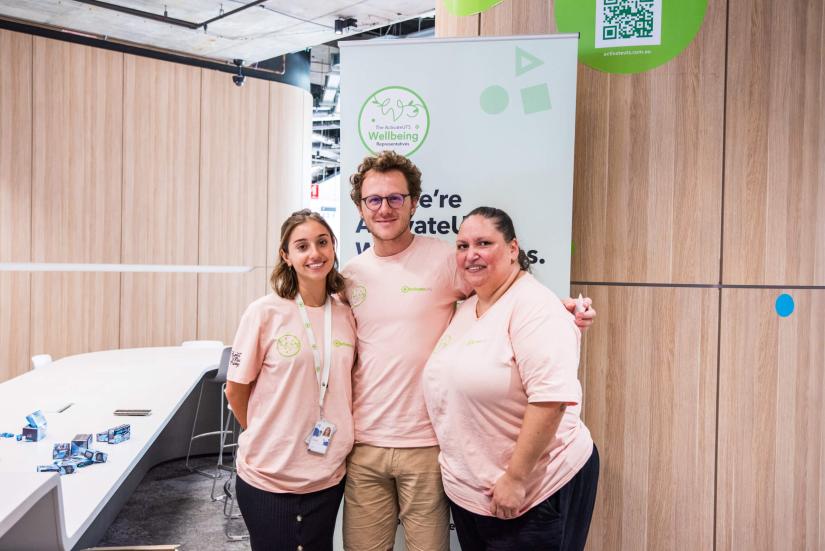 3 people standing together in pink shirts