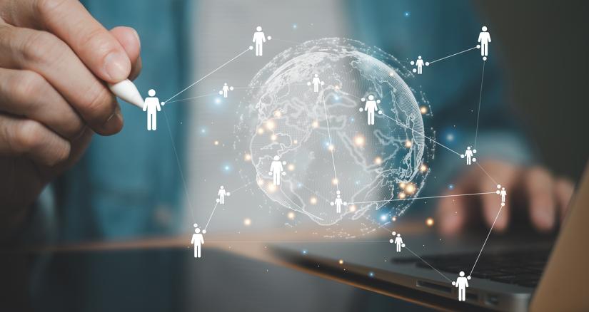 Business person manipulating a map of the globe with people connections