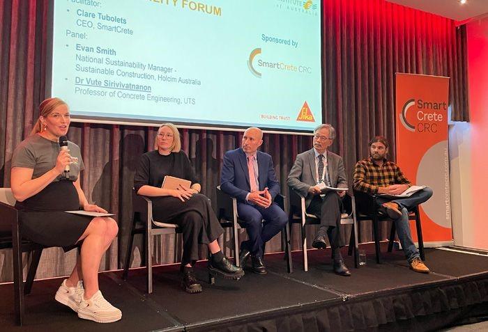 Panel members speaking onstage at the Concrete 2023 Conference